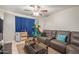 Relaxing living room with a brown sofa, glass table, and a ceiling fan to keep you cool at 113 N Ridge Cir, Mesa, AZ 85203