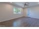 Neutral bedroom with updated flooring, a ceiling fan and a bright window at 14006 N Tumblebrook Way, Sun City, AZ 85351