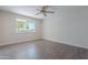 Bedroom featuring wood floors and a window with a view of the outdoors at 14006 N Tumblebrook Way, Sun City, AZ 85351