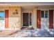 Inviting front entrance showcasing brick accents, a dark door, and a stylish wall-mounted lantern at 14006 N Tumblebrook Way, Sun City, AZ 85351