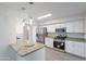 Updated kitchen featuring stainless steel appliances, granite countertops, and white cabinetry at 14006 N Tumblebrook Way, Sun City, AZ 85351