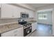 Bright kitchen featuring stainless steel appliances and granite countertops and tile flooring at 14006 N Tumblebrook Way, Sun City, AZ 85351