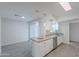 Bright kitchen featuring granite counters, stainless steel appliances, and sleek white cabinetry at 14006 N Tumblebrook Way, Sun City, AZ 85351