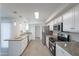 Modern kitchen with stainless steel appliances, granite counters, and updated cabinets at 14006 N Tumblebrook Way, Sun City, AZ 85351