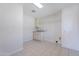 Bright laundry room with tile flooring, utility sink, and storage at 14006 N Tumblebrook Way, Sun City, AZ 85351