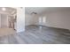 Open living room adjacent to the updated kitchen with french doors and stylish flooring at 14006 N Tumblebrook Way, Sun City, AZ 85351