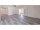 Bright living room with grey wood-look floors and a ceiling fan and sliding glass doors to the back patio at 14006 N Tumblebrook Way, Sun City, AZ 85351