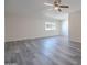 Inviting living room featuring gray flooring, ceiling fan, and a large window at 14006 N Tumblebrook Way, Sun City, AZ 85351