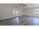 Open-concept living room with french doors, modern ceiling fan, and stylish gray flooring at 14006 N Tumblebrook Way, Sun City, AZ 85351