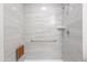 Modern walk-in shower with gray tile, a built-in bench and grab bar at 14006 N Tumblebrook Way, Sun City, AZ 85351