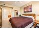 Bedroom featuring a large bed, closet, and ensuite bath at 14950 W Mountain View Blvd # 4103, Surprise, AZ 85374