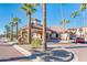 Inviting clubhouse entrance with a decorative water feature, palm trees and nearby parking at 14950 W Mountain View Blvd # 4103, Surprise, AZ 85374