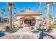 Elegant clubhouse entrance featuring a water fountain, arched entryway, and lush landscaping at 14950 W Mountain View Blvd # 4103, Surprise, AZ 85374