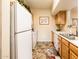 Functional kitchen with white appliances and wooden cabinets, offering ample storage and workspace at 14950 W Mountain View Blvd # 4103, Surprise, AZ 85374