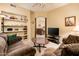 Inviting living room with plush sofas, shelves, and natural light at 14950 W Mountain View Blvd # 4103, Surprise, AZ 85374