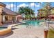 Community pool featuring lounge chairs, shade umbrellas, and a hot tub for resident relaxation at 14950 W Mountain View Blvd # 4103, Surprise, AZ 85374