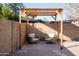 Charming backyard features a pergola with seating area, creating a relaxing outdoor retreat at 15440 N 54Th St, Scottsdale, AZ 85254