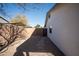 Private backyard with gravel landscaping, a block wall, and gated access on the side of the house at 15440 N 54Th St, Scottsdale, AZ 85254