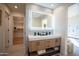 Stylish bathroom with double vanity, lighted mirror, modern fixtures, and walk-in closet nearby at 15440 N 54Th St, Scottsdale, AZ 85254