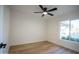 This bedroom has a modern ceiling fan and large window with a view of the neighborhood at 15440 N 54Th St, Scottsdale, AZ 85254