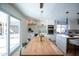 Elegant dining area with a large wooden table, modern lighting, and sliding glass doors to the outdoor patio at 15440 N 54Th St, Scottsdale, AZ 85254