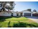 Charming single-story home featuring a well-manicured lawn and a two car garage at 15440 N 54Th St, Scottsdale, AZ 85254