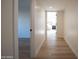 Hallway view to the primary bedroom with wood flooring and neutral paint at 15440 N 54Th St, Scottsdale, AZ 85254