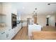 Spacious kitchen with white cabinetry, stainless steel appliances, and an expansive quartz island at 15440 N 54Th St, Scottsdale, AZ 85254