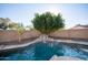 Backyard pool features a small waterfall and privacy wall at 15440 N 54Th St, Scottsdale, AZ 85254