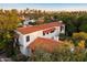 Stunning aerial view of a home with a red tile roof, set against a backdrop of a vibrant cityscape at 1614 Palmcroft Sw Dr, Phoenix, AZ 85007