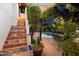 Tile staircase leads to an outdoor dining area and pool for seamless indoor-outdoor enjoyment at 1614 Palmcroft Sw Dr, Phoenix, AZ 85007