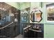 Chic bathroom with black tile, glass shower, pedestal sink, and unique vintage lighting at 1614 Palmcroft Sw Dr, Phoenix, AZ 85007