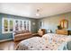 Bedroom featuring two beds, hardwood floors, a ceiling fan, and a comfortable sitting area at 1614 Palmcroft Sw Dr, Phoenix, AZ 85007