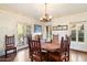 Charming dining room featuring a rustic table, wood floors, and ample natural light at 1614 Palmcroft Sw Dr, Phoenix, AZ 85007