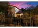 Beautiful home featuring desert landscaping, a red tile roof and a striking red front door beneath a colorful evening sky at 1614 Palmcroft Sw Dr, Phoenix, AZ 85007