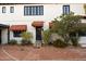 Charming exterior with brick driveway, awnings, and colorful tiled steps at 1614 Palmcroft Sw Dr, Phoenix, AZ 85007