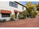 Inviting home facade showcasing brick driveway, classic awnings, and a tiled entrance at 1614 Palmcroft Sw Dr, Phoenix, AZ 85007