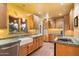 Cozy kitchen with custom wood cabinetry, a farmhouse sink, and tiled countertops at 1614 Palmcroft Sw Dr, Phoenix, AZ 85007