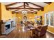 Bright living room featuring wood floors, wood beams, fireplace, and large windows at 1614 Palmcroft Sw Dr, Phoenix, AZ 85007