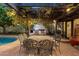 Inviting outdoor dining area with a full kitchen, pergola, and easy access to the pool at 1614 Palmcroft Sw Dr, Phoenix, AZ 85007