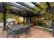 Outdoor patio with wrought iron dining table and chairs, BBQ and a pergola covered with vines at 1614 Palmcroft Sw Dr, Phoenix, AZ 85007