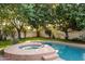 Inviting pool and spa offer a relaxing escape with mature trees and ample sunlight at 1614 Palmcroft Sw Dr, Phoenix, AZ 85007