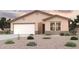 Charming single-story home with a neutral color palette, a two-car garage, and well-maintained desert landscaping at 1617 W Posada St, Coolidge, AZ 85128