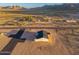 Newly built single-story house with desert landscaping and a freshly paved driveway at 16560 N Slate Ln, Maricopa, AZ 85139