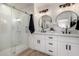 Modern bathroom featuring double sinks, sleek fixtures, and a glass-enclosed shower at 16560 N Slate Ln, Maricopa, AZ 85139