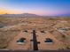 Distant aerial view of homes in a desert neighborhood with mountain views at 16560 N Slate Ln, Maricopa, AZ 85139