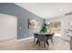 Cozy dining area featuring a modern table, gray upholstered chairs, and natural light at 16560 N Slate Ln, Maricopa, AZ 85139