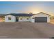 Attractive single-story home with a two-car garage, desert landscaping, and bright natural light at 16560 N Slate Ln, Maricopa, AZ 85139