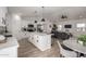 Open concept kitchen flowing into the living area, featuring an island with seating at 16560 N Slate Ln, Maricopa, AZ 85139