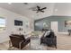 Bright living room featuring wood-look floors, blue accent wall, modern decor, and ample natural light at 16560 N Slate Ln, Maricopa, AZ 85139